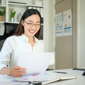 someone smiling while reading a document